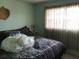 Bright bedroom with a queen-size bed and window at 914 E 2Nd St, Englewood, FL 34223