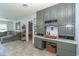 Gray kitchen cabinets and a built-in desk with wine storage at 958 Osceola Blvd, Englewood, FL 34223