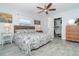 Bright bedroom with king bed, ceiling fan, and walk-in closet at 958 Osceola Blvd, Englewood, FL 34223