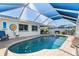 Large kidney shaped pool with screened enclosure at 958 Osceola Blvd, Englewood, FL 34223