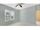 Bright bedroom with a large window and a ceiling fan at 10045 Links Ln # 203, Rotonda West, FL 33947