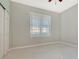 Well-lit bedroom with ceiling fan and window coverings at 10045 Links Ln # 203, Rotonda West, FL 33947