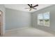 Spacious bedroom with ceiling fan and large window offering scenic views at 10045 Links Ln # 203, Rotonda West, FL 33947
