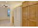 Kitchen with light wood cabinets, white appliances, and a window at 10045 Links Ln # 203, Rotonda West, FL 33947