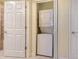 Stackable washer and dryer in a compact laundry room at 10045 Links Ln # 203, Rotonda West, FL 33947