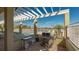Enjoy grilling by the pool under a pergola at 10045 Links Ln # 203, Rotonda West, FL 33947