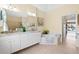 Spa-like bathroom features a corner tub, double vanity, and access to the pool at 10322 Sunbury Dr, Port Charlotte, FL 33981