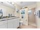 Bathroom boasts granite countertops, walk-in shower, and coastal decor at 10322 Sunbury Dr, Port Charlotte, FL 33981