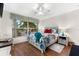 Bright bedroom with wood floors, large window, and tropical bedding at 10322 Sunbury Dr, Port Charlotte, FL 33981