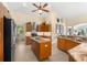 Modern kitchen with wood cabinets, granite counters, and island at 10322 Sunbury Dr, Port Charlotte, FL 33981