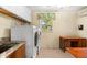 Laundry room with washer, dryer, and built-in storage at 10322 Sunbury Dr, Port Charlotte, FL 33981