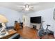 Home office with wood floors, exercise bike, and plenty of space at 10322 Sunbury Dr, Port Charlotte, FL 33981