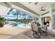 Relaxing pool area with covered patio, spa, and canal views at 10322 Sunbury Dr, Port Charlotte, FL 33981