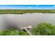 Drone view of waterfront property with private dock and lush landscaping at 10360 Longshore Rd # 66, Placida, FL 33946