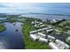 Community of townhouses near the water, with lush landscaping and a view of the coastline at 10360 Longshore Rd # 66, Placida, FL 33946