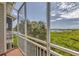 Screened balcony overlooking lush landscape and water at 10360 Longshore Rd # 66, Placida, FL 33946
