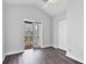Bright bedroom with wood-look floors and access to a private balcony at 10360 Longshore Rd # 66, Placida, FL 33946