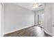 Bedroom with balcony access and wood-look floors at 10360 Longshore Rd # 66, Placida, FL 33946