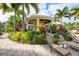 Relaxing clubhouse patio with lounge chairs and tropical landscaping at 10360 Longshore Rd # 66, Placida, FL 33946