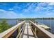 Wooden walkway leads to a floating dock on calm water at 10360 Longshore Rd # 66, Placida, FL 33946