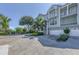 Three-story townhouse with attached garage and lush landscaping at 10360 Longshore Rd # 66, Placida, FL 33946