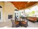 Cozy outdoor seating area with fireplace and wood-beamed ceiling at 10360 Longshore Rd # 66, Placida, FL 33946