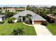 One-story house with a spacious yard, driveway, and surrounding houses at 1042 Boundary Blvd, Rotonda West, FL 33947