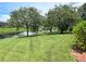 Backyard view of home with lush lawn and canal at 1042 Boundary Blvd, Rotonda West, FL 33947