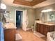 Double vanity bathroom with a walk-in shower and wood cabinets at 1042 Boundary Blvd, Rotonda West, FL 33947