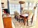 Bright dining room featuring a large wooden table with seating for six at 1042 Boundary Blvd, Rotonda West, FL 33947