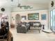 Comfortable living room with sectional sofa and large artwork at 1042 Boundary Blvd, Rotonda West, FL 33947