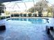 Inviting screened-in pool with stamped concrete decking at 1042 Boundary Blvd, Rotonda West, FL 33947