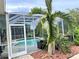 Relaxing pool and patio area with lush landscaping at 1042 Boundary Blvd, Rotonda West, FL 33947