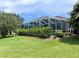Screened pool enclosure with lush landscaping at 1042 Boundary Blvd, Rotonda West, FL 33947