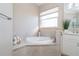 Relaxing bathroom featuring a luxurious soaking tub and window at 10479 Coquina Ct, Placida, FL 33946
