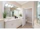 Double vanity bathroom with a large mirror and walk-in shower at 10479 Coquina Ct, Placida, FL 33946