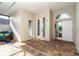Bright and airy entryway with tiled flooring and access to the garage at 10479 Coquina Ct, Placida, FL 33946
