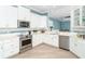 Modern kitchen featuring stainless steel appliances and white shaker cabinets at 10479 Coquina Ct, Placida, FL 33946