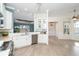 Bright kitchen with white cabinets, stainless steel appliances, and tile floors at 10479 Coquina Ct, Placida, FL 33946
