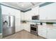 Spacious kitchen with stainless steel appliances and white cabinets at 10479 Coquina Ct, Placida, FL 33946