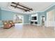 Spacious living room with high ceilings, wood beams, and sliding glass doors at 10479 Coquina Ct, Placida, FL 33946