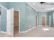 Main bedroom with soft teal walls, plush carpeting, and walk-in closet at 10479 Coquina Ct, Placida, FL 33946