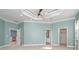Spacious main bedroom with light teal walls and high ceilings at 10479 Coquina Ct, Placida, FL 33946