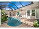 Enclosed pool area with a covered patio and seating at 10479 Coquina Ct, Placida, FL 33946