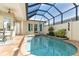 Refreshing kidney-shaped pool with a covered patio at 10479 Coquina Ct, Placida, FL 33946