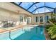 Inviting kidney-shaped pool with covered patio and seating at 10479 Coquina Ct, Placida, FL 33946