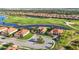 Overhead view of homes nestled against golf course and pond at 10705 Tarflower Dr, Venice, FL 34293