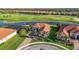 Aerial view of house in cul-de-sac, near pond and golf course at 10705 Tarflower Dr, Venice, FL 34293