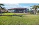 Back of home with view of screened in porch at 10705 Tarflower Dr, Venice, FL 34293