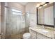 Neutral toned bathroom with glass shower, white toilet and vanity with granite countertop at 10705 Tarflower Dr, Venice, FL 34293